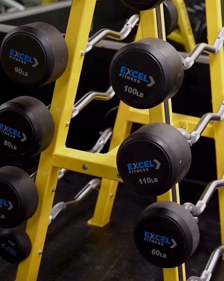 Rack of yellow Excel Fitness weight bars at Fit Nation Norwalk